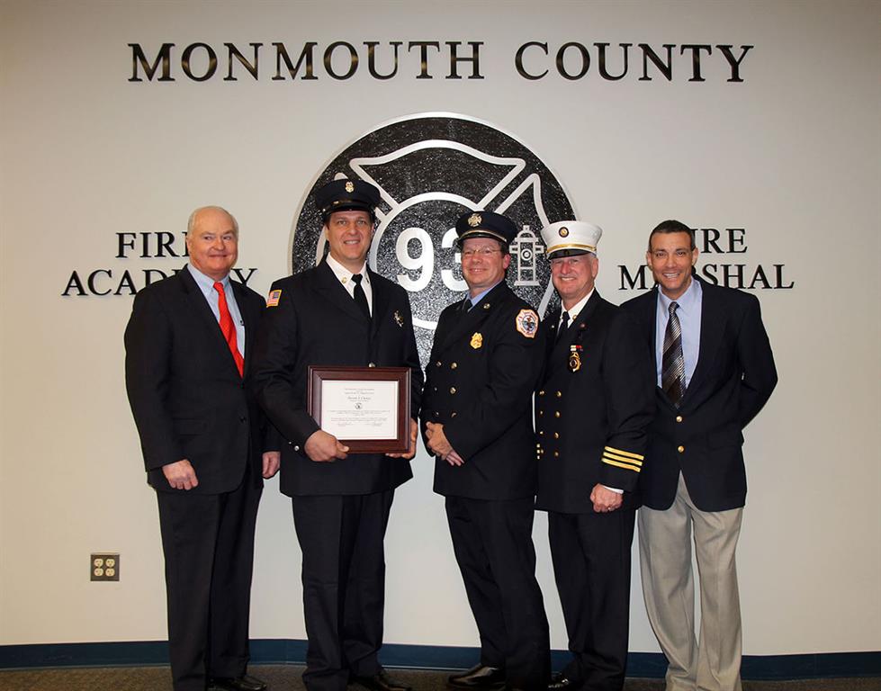 Devon S. Clancy of Sea Girt Fire Department is presented with the Class 108 Ronald Fitzpatrick Firefighter 1 Award at the Monmouth County Fire Academy graduation on Jan. 26, 2016 in Howell, NJ. Pictured left to right: Freeholder John P. Curley, Devon S. Clancy, Steve Fitzpatrick, Monmouth County Fire Marshal Kevin A. Stout and Fire Academy Director Armand Guzzi.